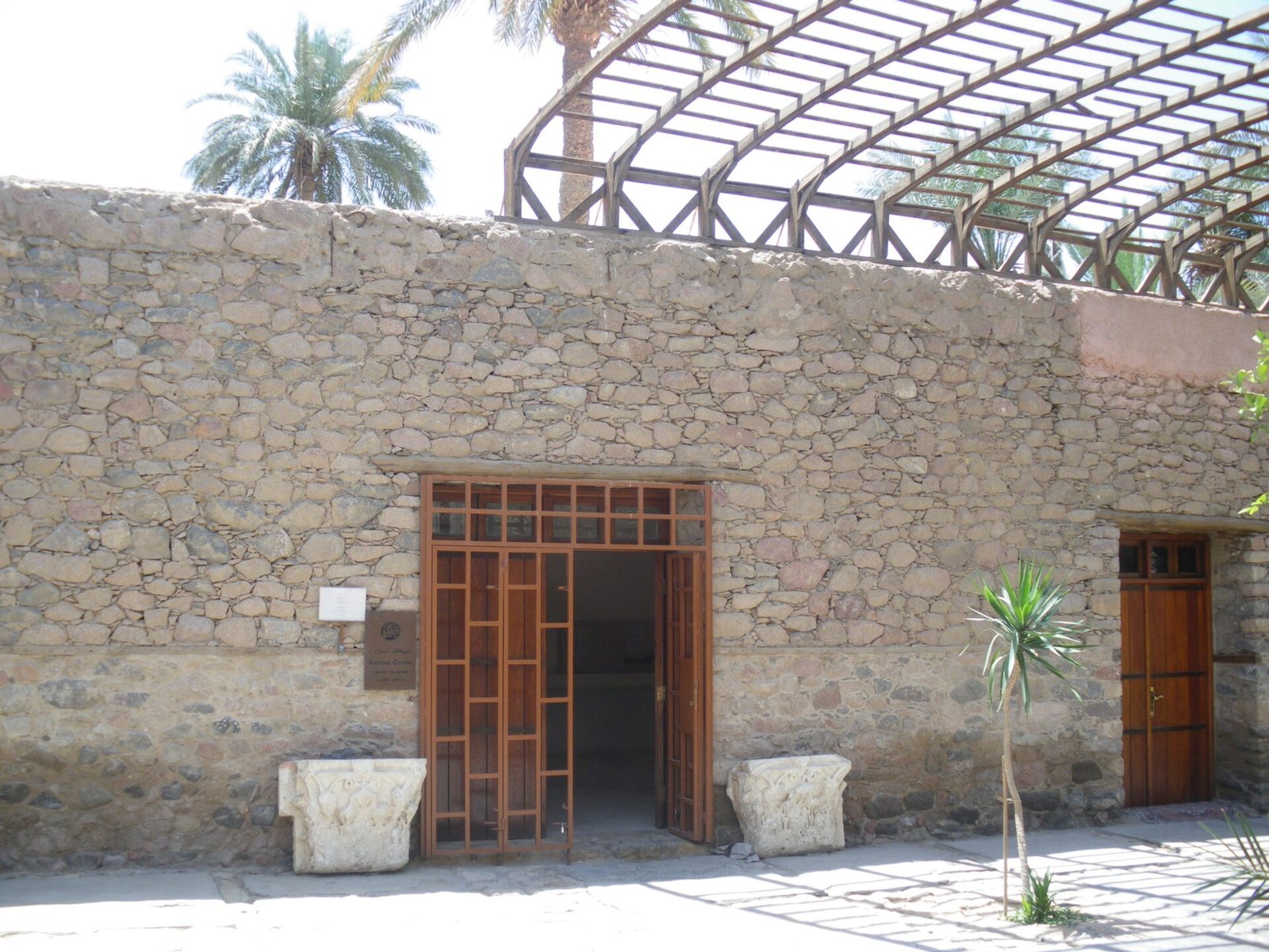 The stone facade and wooden doors of the Aqaba Archaeological Museum, in the house of Sharif Hussein.