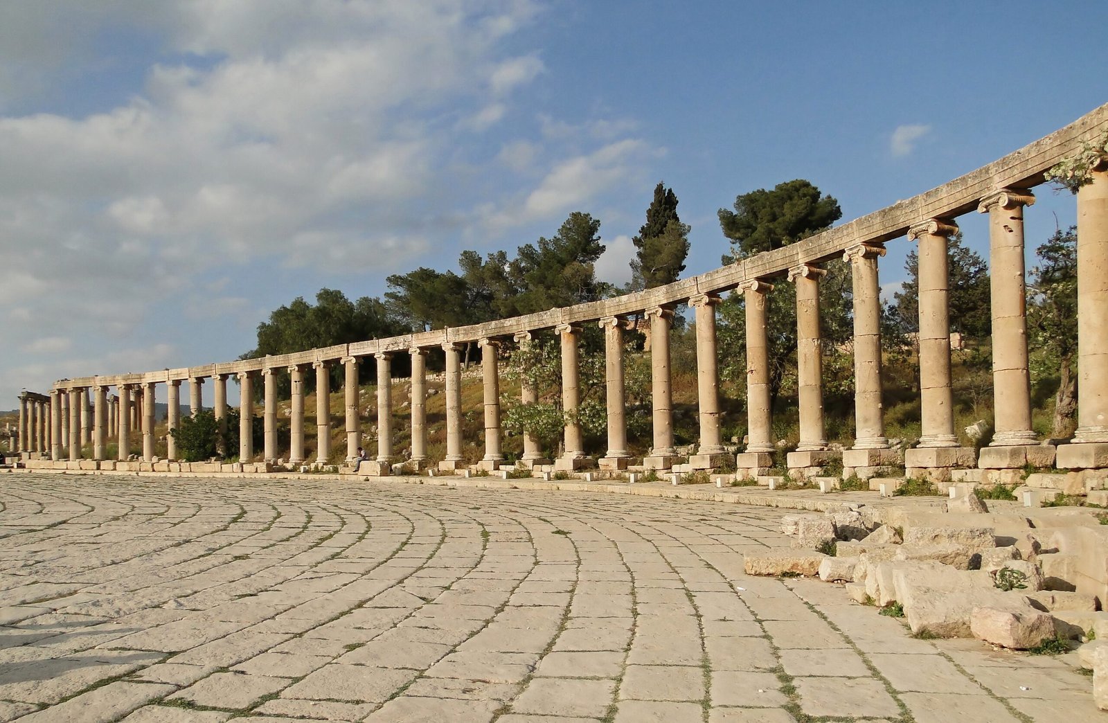 Colonnaded oval forum with a paved stone floor at the Roman ruins of Jerash, Jordan.